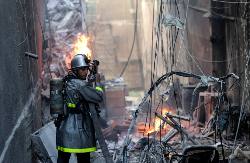  A Palestinian firefighter fights the blaze amid the destruction following an Israeli air strike on Gaza City, on August 5, 2022. (credit: MOHAMMED ABED/AFP via Getty Images)