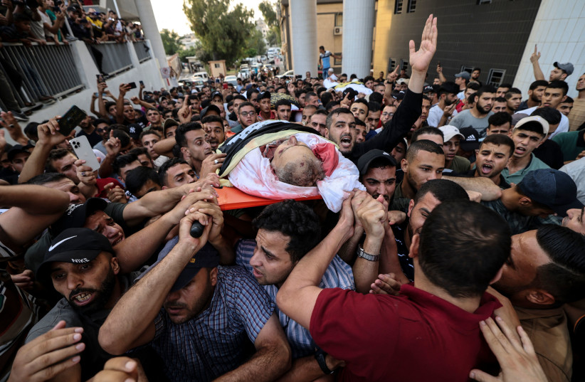  Palestinian mourners carry the body of Islamic Jihad commander Tayseer al-Jabari, killed earlier in an Israeli air strike, during his funeral in Gaza City on August 5, 2022 (credit: MAHMUD HAMS/AFP via Getty Images)