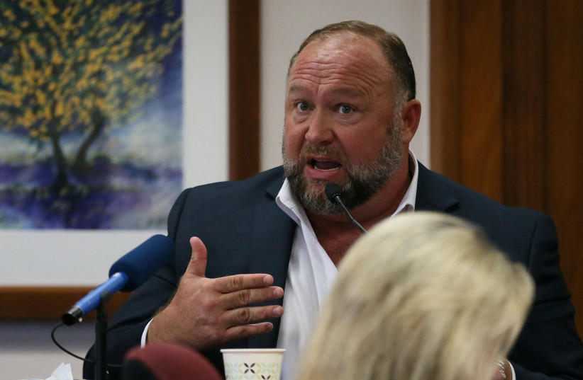 Alex Jones is called up to testify at the Travis County Courthouse during the his defamation trial, in Austin, US, August 2, 2022. (photo credit:  BRIANA SANCHEZ/POOL VIA REUTERS)
