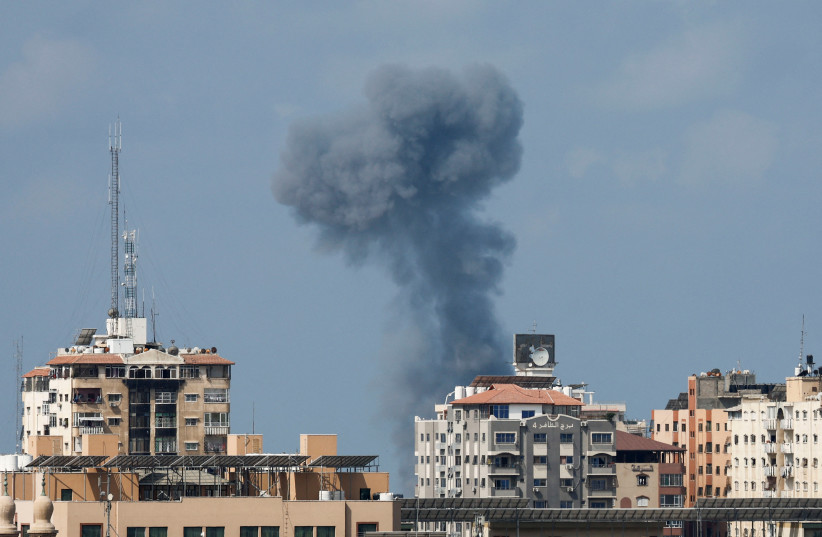  Smoke rises during an Israeli air strike, amid Israel-Gaza fighting, in Gaza City August 6, 2022 (credit: IBRAHEEM ABU MUSTAFA/REUTERS)