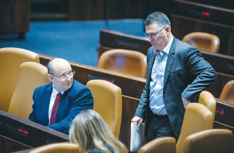  THEN-PRIME MINISTER Naftali Bennett glances at Justice Minister Gideon Sa’ar during a debate in the Knesset plenum, earlier this year. (photo credit: OLIVIER FITOUSSI/FLASH90)