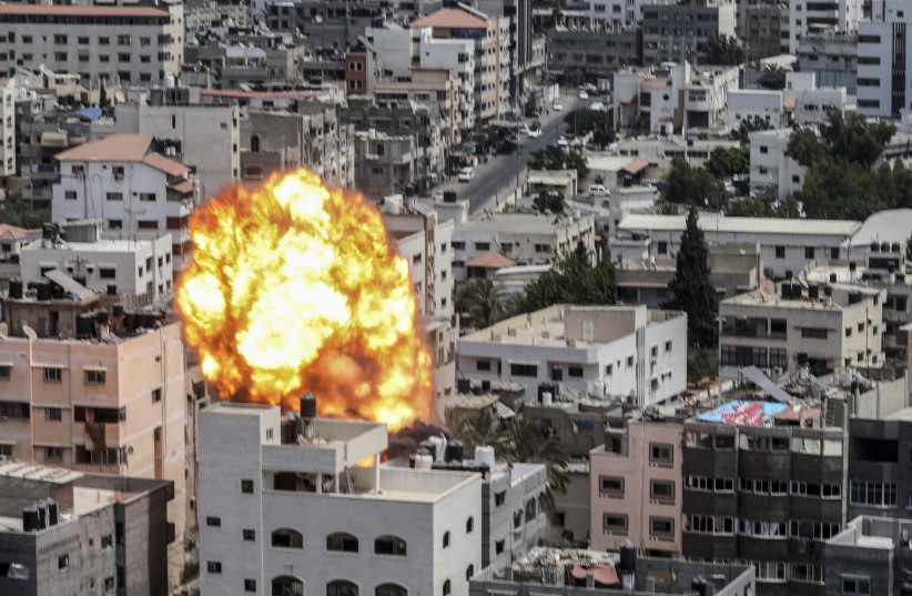  A fireball and smoke erupt following an Israeli air strike on a building in Gaza City, on August 6, 2022. (photo credit: ATTIA MUHAMMED/FLASH90)