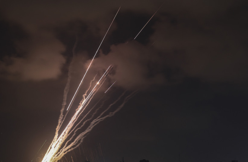  A salvo of rockets is fired from Gaza City toward Israel, on August 6, 2022.  (credit: MOHAMMED ABED/AFP/GETTY IMAGES)
