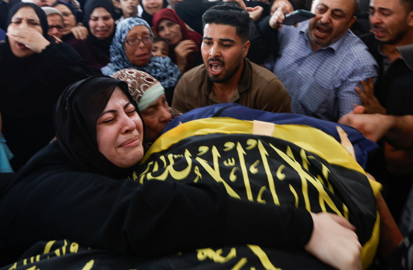  Mourners react during the funeral of senior Palestinian commander of Islamic Jihad militant group Khaled Mansour, who was killed in Israeli air strikes, in Rafah in the southern Gaza Strip, August 7, 2022. (credit: IBRAHEEM ABU MUSTAFA/REUTERS)