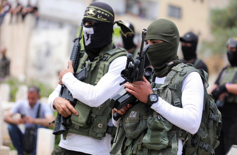 Islamic Jihad militants attend the funeral of Palestinian militant Amjad Al Fayedin, who was killed in clashes during an Israeli raid, in Jenin in the Israeli-occupied West Bank, May 21, 2022. (credit: REUTERS/RANEEN SAWAFTA)