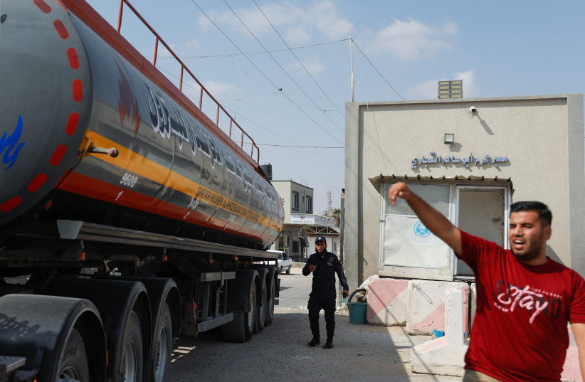  A truck carrying fuel imports for the lone power plant rolls into Gaza, after Israel eased up closures, as ceasefire holds in Rafah in the southern Gaza Strip, August 8, 2022.  (photo credit: REUTERS/IBRAHEEM ABU MUSTAFA)