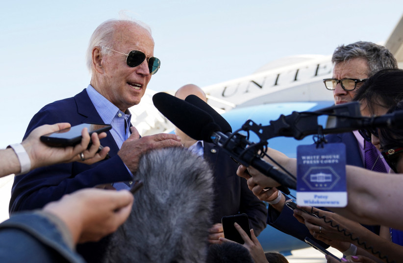  US President Joe Biden talks to reporters while boarding Air Force One on travel to Eastern Kentucky to visit families affected by devastation from recent flooding, as he departs from Delaware Air National Guard Base in New Castle, Delaware, US, August 8, 2022.  (photo credit: REUTERS/KEVIN LAMARQUE)