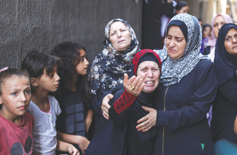  RELATIVES MOURN during the funeral of four teenage Palestinian cousins in Jabaliya. Al Jazeera blamed Israel for the death of children in Jabaliya, without mentioning that it was the result of an errant Islamic Jihad rocket, says the writer.  (photo credit: SUHAIB SALEM/REUTERS)