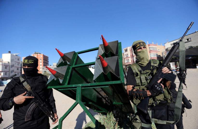 Palestinian Islamic jihad militants display rockets during a military show marking the 32nd anniversary of the organisation's founding, in the central Gaza Strip October 3, 2019. (photo credit: IBRAHEEM ABU MUSTAFA/REUTERS)