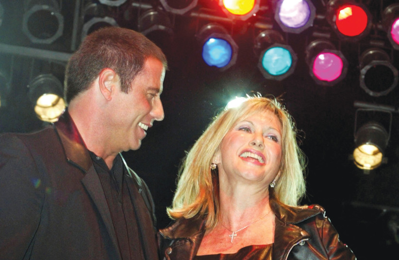  JOHN TRAVOLTA and Olivia Newton-John perform a song from their classic film ‘Grease’ during a party at Paramount studios in 2002.  (credit: FRED PROUSER/REUTERS)