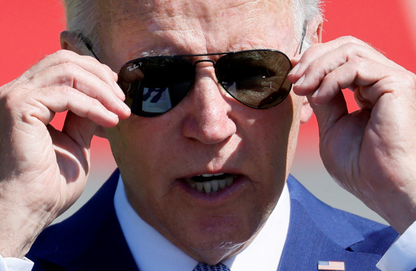  US President Joe Biden adjusts his glasses as he delivers remarks during a signing event for the CHIPS and Science Act of 2022, on the South Lawn of the White House in Washington, US, August 9, 2022.  (photo credit: REUTERS/EVELYN HOCKSTEIN)