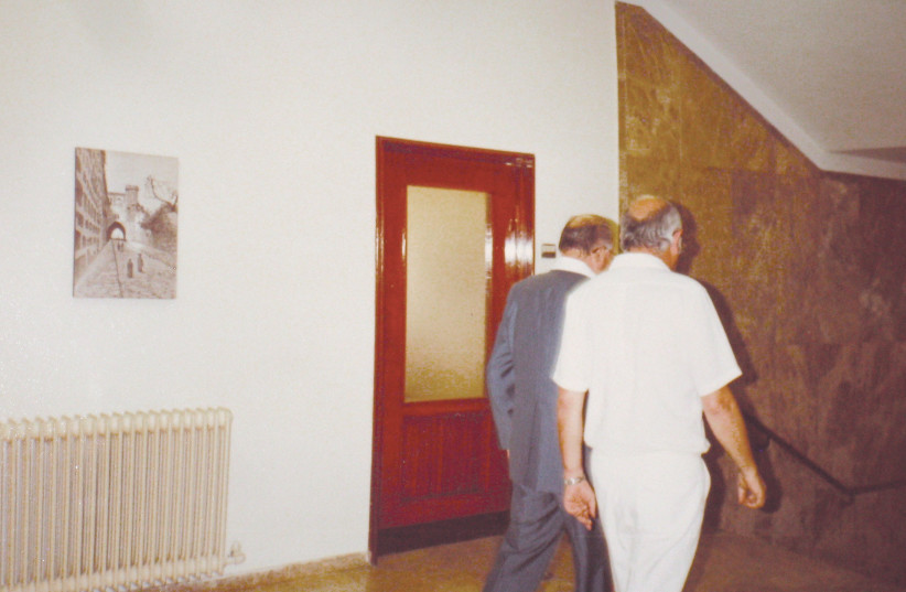  Begin walking away with his aide, after his encounter with the author in Yechiel Kadishai’s office. (credit: STEVE NORTH)