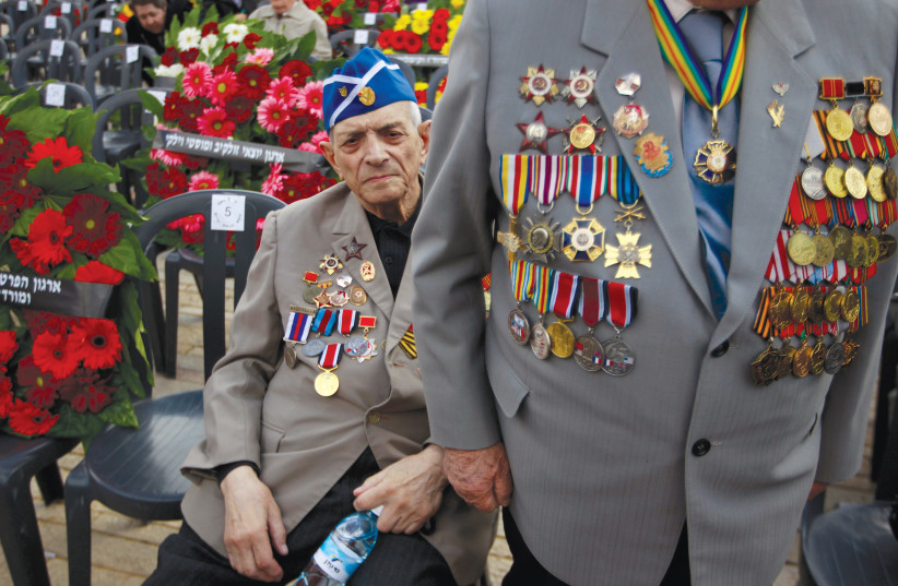  Illustrative photo of World War II veterans attending a wreath-laying ceremony at Yad Vashem.  (credit: AMMAR AWAD/REUTERS)