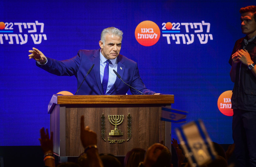  Prime Minister and Yesh Atid chairman Yair Lapid speaks to party members during a Yesh Atid party conference in Tel Aviv, August 3, 2022 (credit: AVSHALOM SASSONI/FLASH90)