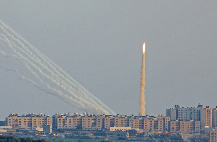  IRON DOME missile takes off near Ashkelon, as rockets are launched in the background from the Gaza Strip toward Israel (credit: JACK GUEZ/AFP VIA GETTY IMAGES)