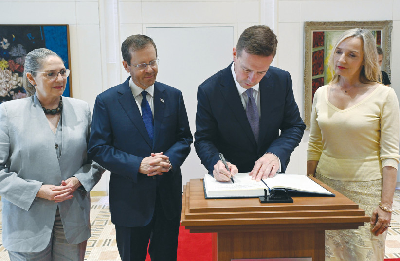  WHILE HIS wife Sophia Grundelach (right) and President Isaac Herzog and his wife Michal look on, German Ambassador Steffen Seibert signs the guest book at the President’s Residence after presenting his credentials (photo credit: HAIM ZACH/GPO)