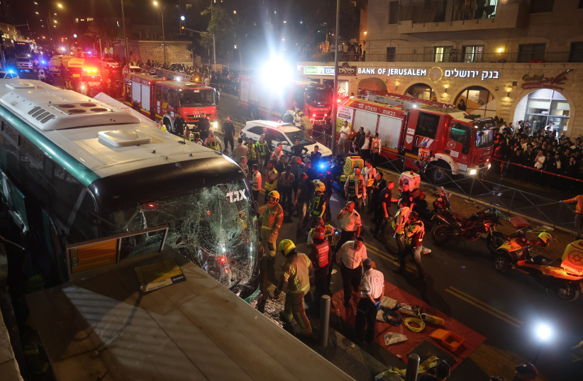  Police and rescue personnel at the scene of where a bus lost control and plowed into a store in central Jerusalem, killing at least two people. August 11, 2022.  (photo credit: YONATAN SINDEL/FLASH90)