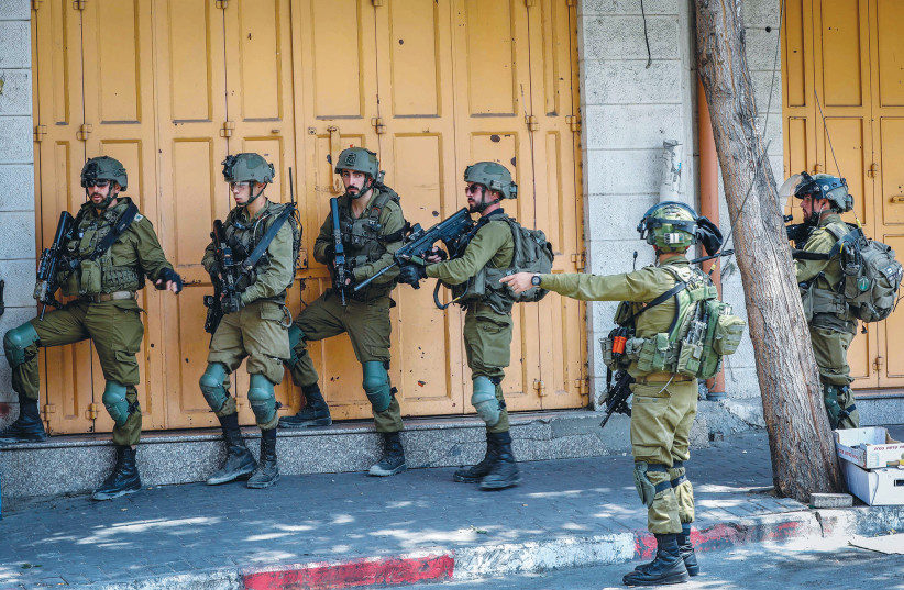  IDF SOLDIERS operate in Hebron, this week: Israel must ensure that the West Bank is not militarized over the long term with its own forces, says the writer (credit: WISAM HASHLAMOUN/FLASH90)