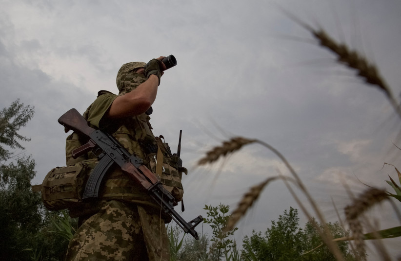  A Ukrainian serviceman checks an area at a position in a front line in Mykolaiv region, as Russia's attack on Ukraine continues, Ukraine August 11, 2022. (photo credit: REUTERS/ANNA KUDRIAVTSEVA)