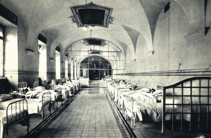 Patients lay in beds in the ''Syndrome K'' unit at Fatebenefratelli Hospital. (credit: ''SYNDROME K'' FREESTYLE DIGITAL MEDIA/VIA JTA)