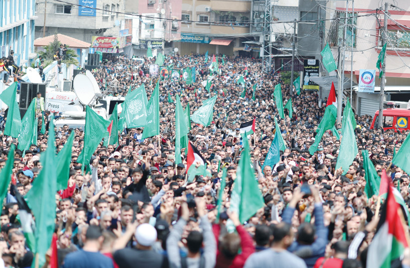  HAMAS SUPPORTERS hold a rally in the northern Gaza Strip, earlier this year. Israel and Egypt strengthened the position of Hamas as sovereign and a significant player in the Palestinian arena, say the writers.  (credit: MOHAMMED SALEM/REUTERS)