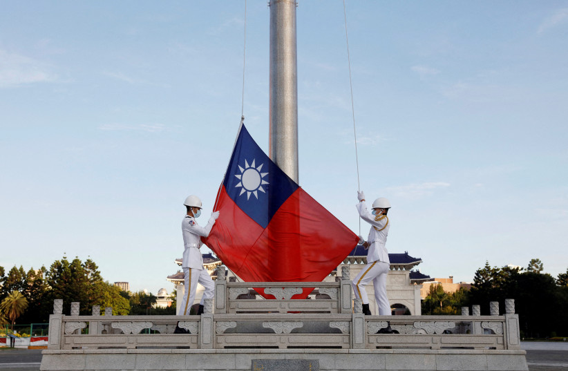 Honour guard members take part in a flag-raising ceremony at Chiang Kai-shek Memorial Hall in Taipei, Taiwan August 6, 2022. (credit: REUTERS/Jameson Wu/File Photo)