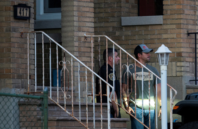  A New Jersey police officer and a plain-clothed police officer exit the building where alleged attacker of Salman Rushdie, Hadi Matar, lives in Fairview, New Jersey, US, August 12, 2022. (credit: EDUARDO MUNOZ / REUTERS)