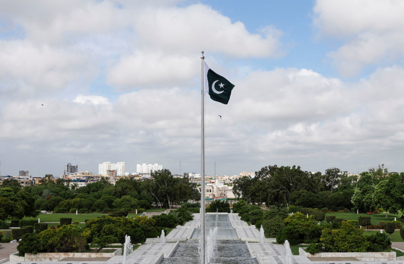 Pakistan's national flag flatters during a ceremony to celebrate Pakistan's 75th Independence Day, at the Mausoleum of Muhammad Ali Jinnah in Karachi, Pakistan, August 14, 2022. (credit: REUTERS/AKHTAR SOOMRO)