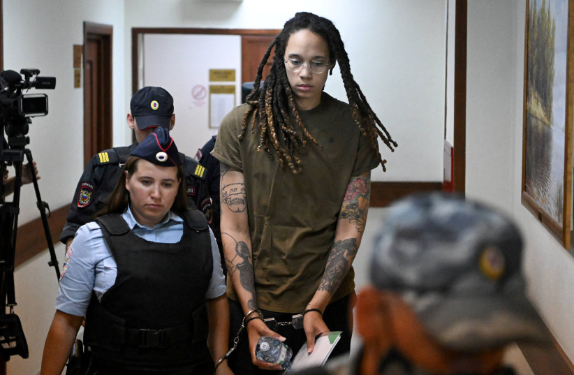  US basketball player Brittney Griner, who was detained at Moscow's Sheremetyevo airport and later charged with illegal possession of cannabis, is escorted before a court hearing in Khimki outside Moscow, Russia August 2, 2022. (credit: NATALIA KOLESNIKOVA/POLL VIA REUTERS)