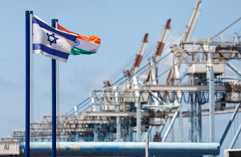  Israeli and Indian national flags fly at Haifa Port, which is to be sold to India's Adani Ports and local partner Gadot, in Haifa, Israel July 24, 2022. (credit: REUTERS/AMIR COHEN)