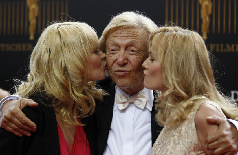  German Nightclub owner Rolf Eden with two unidentified girls pose on the red carpet before the German Film Prize (Lola) ceremony in Berlin April 27, 2012. (photo credit: REUTERS/THOMAS PETER)