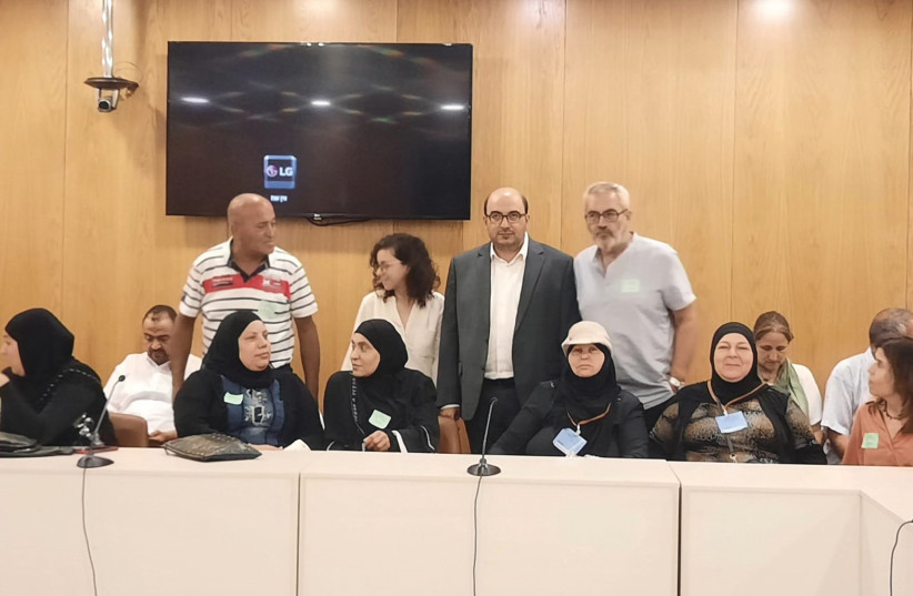  MK SAMI Abu Shehadeh of the Joint List (wearing a jacket) poses at a meeting he chaired in the Knesset recently on the issue of Jaffa evictions. (photo credit: ELANA SZTOKMAN)