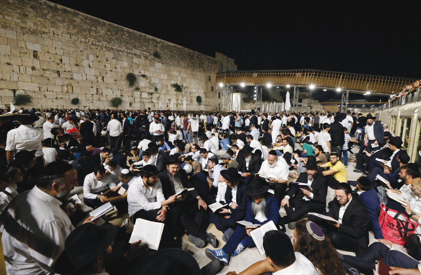  MEN PRAY at the Western Wall on the eve of Tisha Be’av, earlier this month. ‘The New York Times’ wrote last year that ‘The Western Wall is now used mostly by Jewish worshipers despite its also being important to Muslims.’  (photo credit: OLIVIER FITOUSSI/FLASH90)