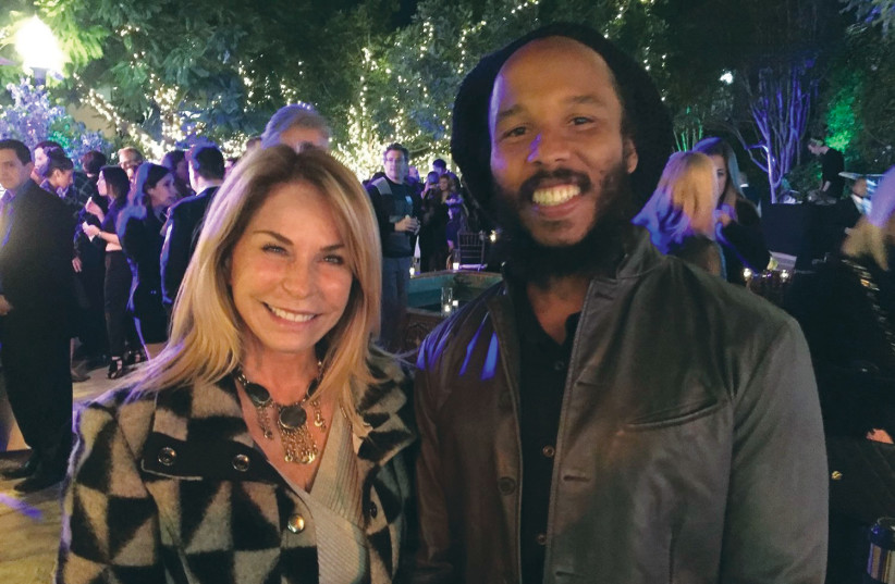  LANA MELMAN with singer-songwriter Ziggy Marley in Los Angeles, 2005; Melman was a Hollywood liaison for JNF Young Professionals. (photo credit: Lana Melman)