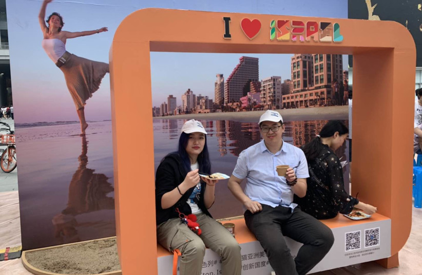 Sitting in front of a Tel Aviv view sign (credit: Embassy of Israel in China)