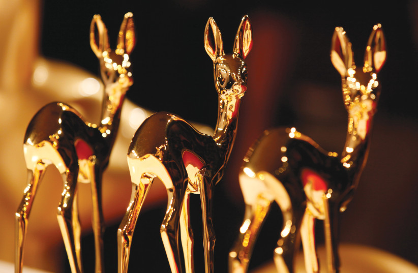  THREE BAMBI Award gold-plated statuettes of a roe deer fawn at the award ceremony in Germany. (photo credit: Wolfgang Rattay/Reuters)