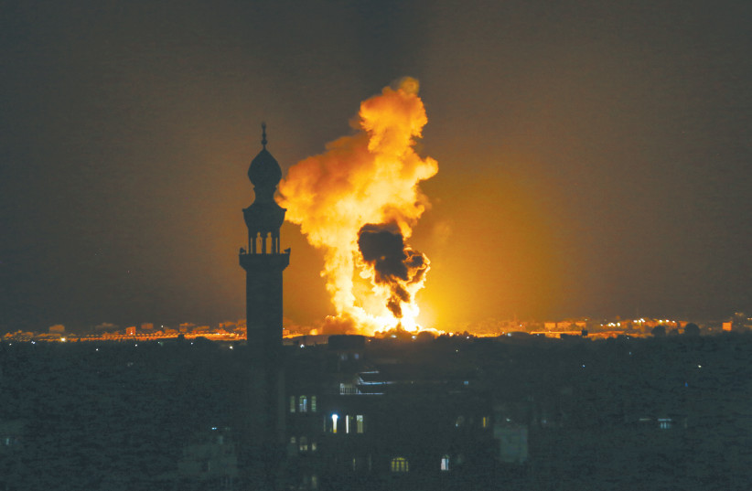  A BALL of fire and smoke rises during an Israeli air strike in Khan Yunis, Gaza Strip, earlier this month. Escalations in Gaza can impact Jewish interests, say the writers (photo credit: ABED RAHIM KHATIB/FLASH90)