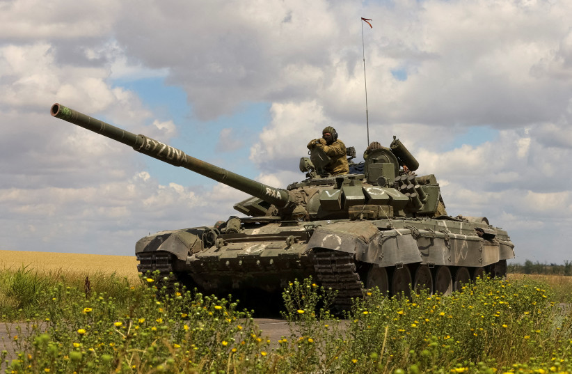 A tank of Russian troops drives in Russian-held part of Zaporizhzhia region, Ukraine, July 23, 2022. (credit: REUTERS/Alexander Ermochenko/File Photo)