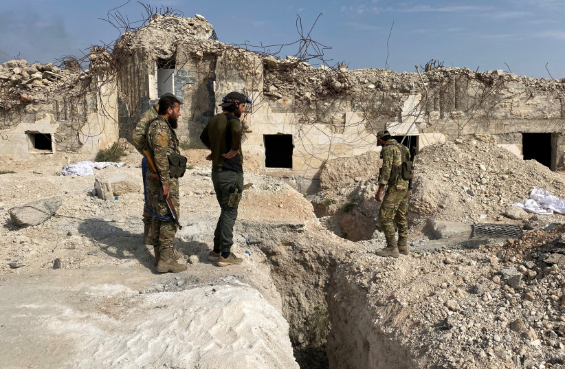 Turkey-backed Syrian rebel fighters stand near underground tunnels said to be made by the Syrian Democratic Forces (SDF) in Tal Abyad, Syria, October 17, 2019. (credit: REUTERS/MAHMOUD HASSANO)