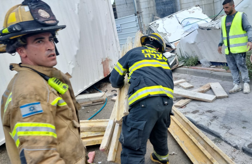  Tirat Ha'Karmel firefighters are currently working on rescuing two more workers who are still trapped under the rubble at the scene (photo credit: FIREFIGHTERS AND RESCUE NORTH DISTRICT SPOKSEPERSON)