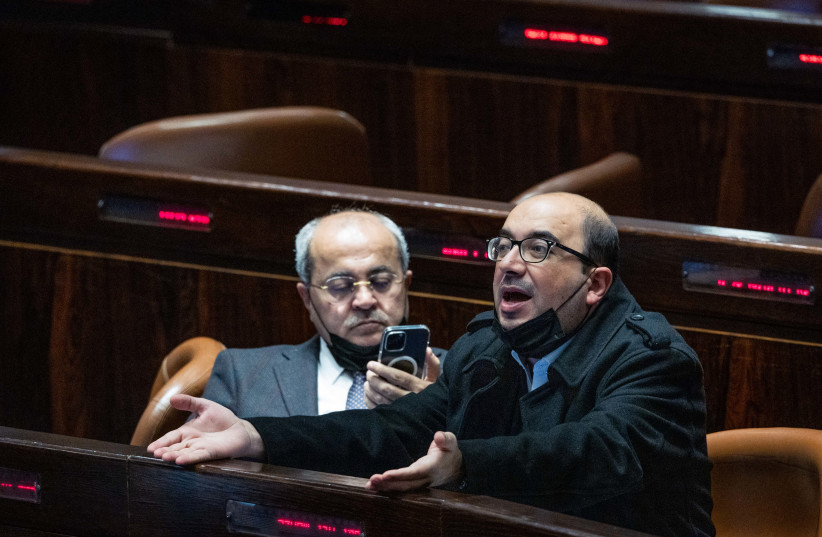  MK's Sami Abu Shehadeh and Ahmad Tibi seen during a plenum session in the assembly hall of the Israeli parliament in Jerusalem, February 23, 2022. (photo credit: YONATAN SINDEL/FLASH90)