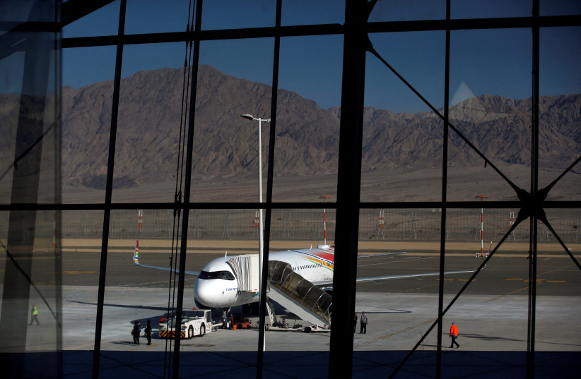  A plane is reflected in the facade of the Ramon International Airport after an inauguration ceremony for the new airport, just outside the southern Red Sea resort city of Eilat, Israel January 21, 2019.  (credit: REUTERS/Ronen Zvulun)