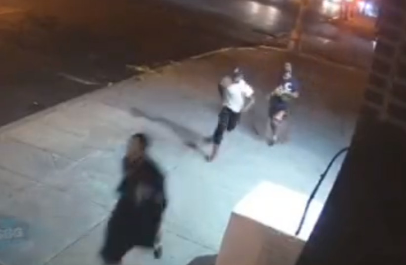 Two youths chase an ultra-Orthodox man in Williamsburg, Brooklyn, New York. (photo credit: screenshot)