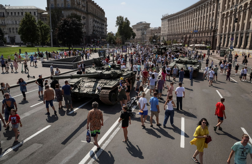 People attend an exhibition displaying destroyed Russian military vehicles located on the main street Khreshchatyk as part of the upcoming celebration of the Independence Day of Ukraine, amid Russia's invasion, in central Kyiv, Ukraine August 21, 2022.  (credit: REUTERS/GLEB GARANICH)