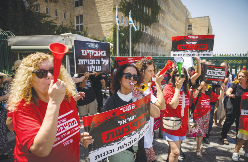  TEACHERS DEMONSTRATE outside the Finance Ministry in Jerusalem, last week. Their signs say that they’re fighting for their rights and that poor working conditions have resulted in fewer teachers. (photo credit: YONATAN SINDEL/FLASH 90)