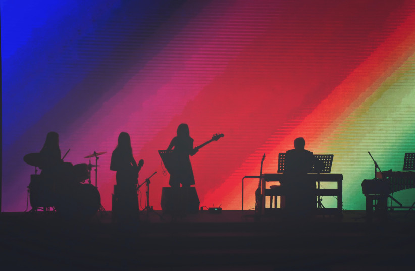  Band members playing on stage (stock photo). (credit: CREATIVE COMMONS)