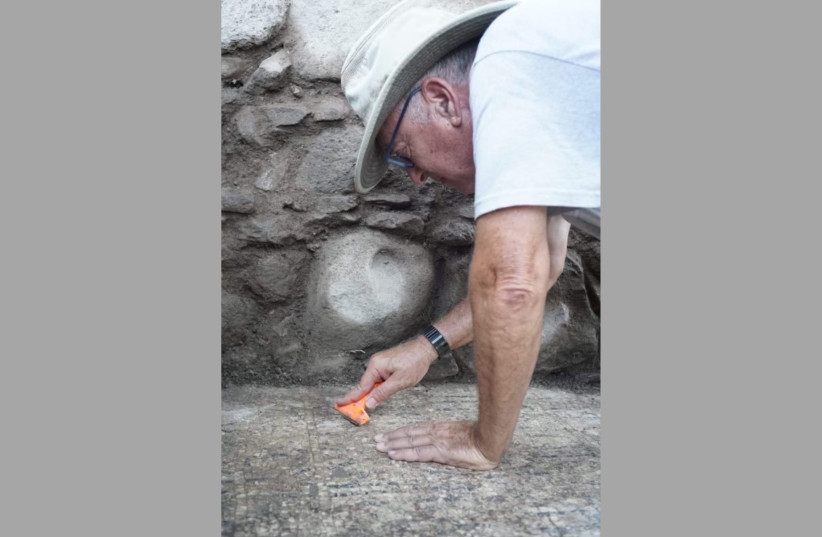 Prof. Mordechai Aviam cleaning the inscription. (credit: Zachary Wong)