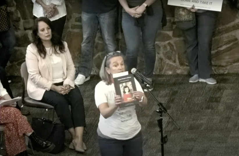 Gretchen Veling reads aloud from ''Anne Frank's Diary: The Graphic Adaptation'' at a board meeting for the Keller Independent School District in Keller, Texas, Aug. 22, 2022. The district had ordered the removal of the book from its schools the week prior (credit: SCREENSHOT/VIA JTA)