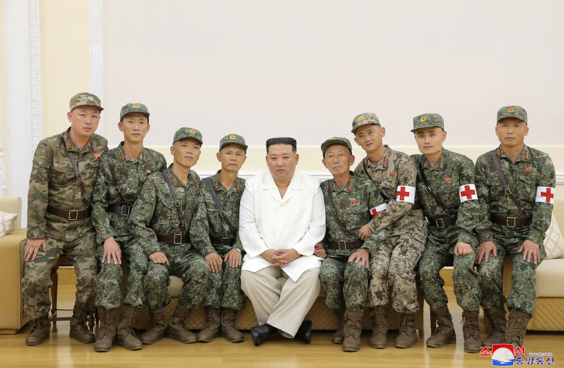  North Korea's leader Kim Jong Un poses for a photo with Korean People's Army medics during a meeting to recognise their contributions in fighting the coronavirus disease (COVID-19) pandemic in Pyongyang, North Korea, August 18, 2022. (photo credit: KOREAN CENTRAL NEWS AGENCY KCNA VIA REUTERS)