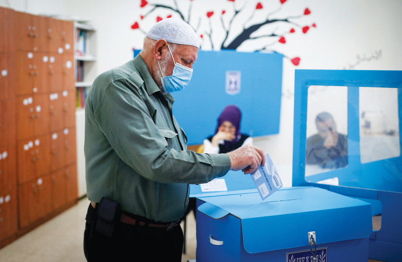  AN ARAB-ISRAELI man casts a vote in Kafr Manda in the North (photo credit: REUTERS)